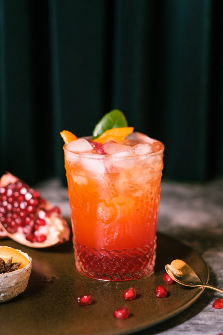 oragne juice mixed with pomegranate cocktail beverage drink on table