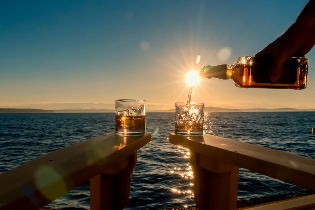 Pouring drinks outside at sunset