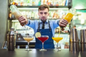 The barman making cocktails on the bar